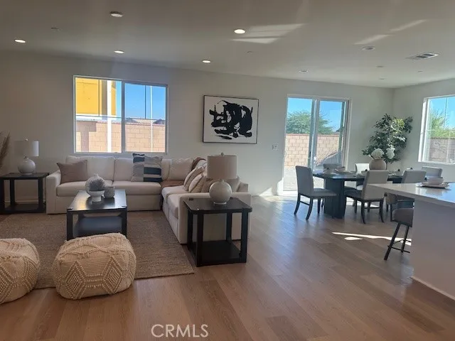 a living room with furniture and floor to ceiling windows
