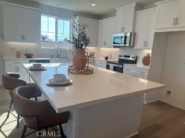 a kitchen with furniture a sink a stove and a refrigerator