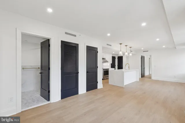 a view of a kitchen with refrigerator and a sink