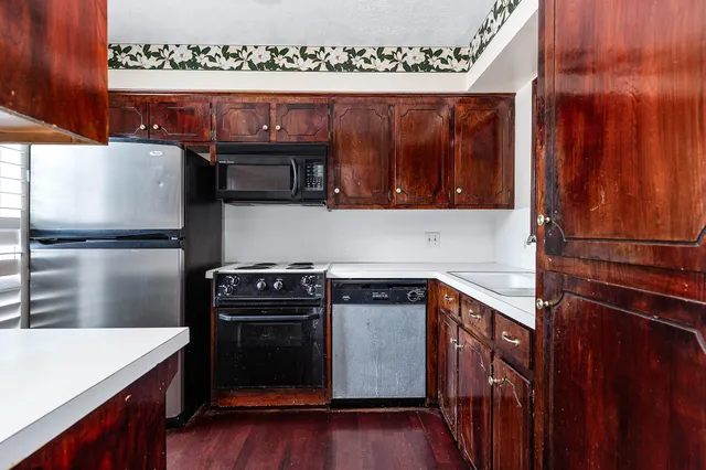 a kitchen with stainless steel appliances granite countertop a stove a microwave and a refrigerator