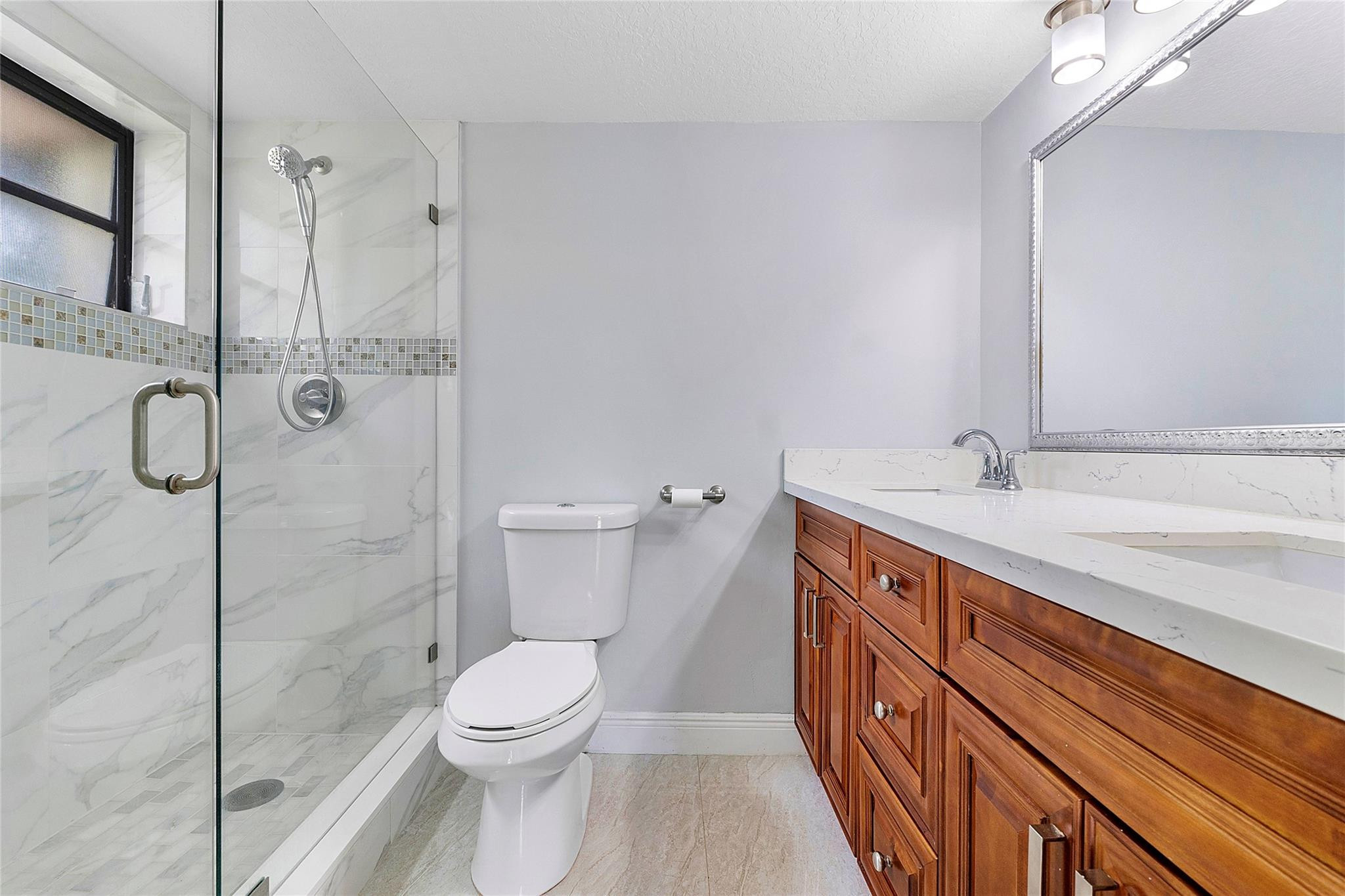 6593 Spring Bottom Way, Unit 237 Boca Raton, FL 33433 - Photo 11 of 49 a bathroom with a sink a toilet and shower