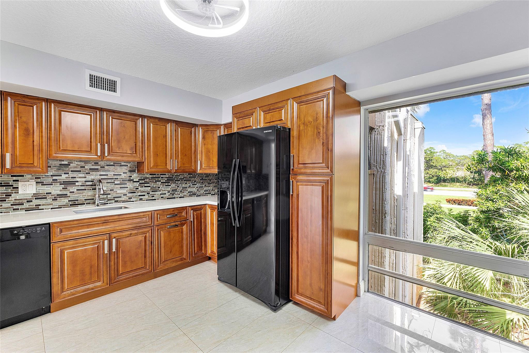 6593 Spring Bottom Way, Unit 237 Boca Raton, FL 33433 - Photo 12 of 49 a kitchen with stainless steel appliances granite countertop a refrigerator and a sink