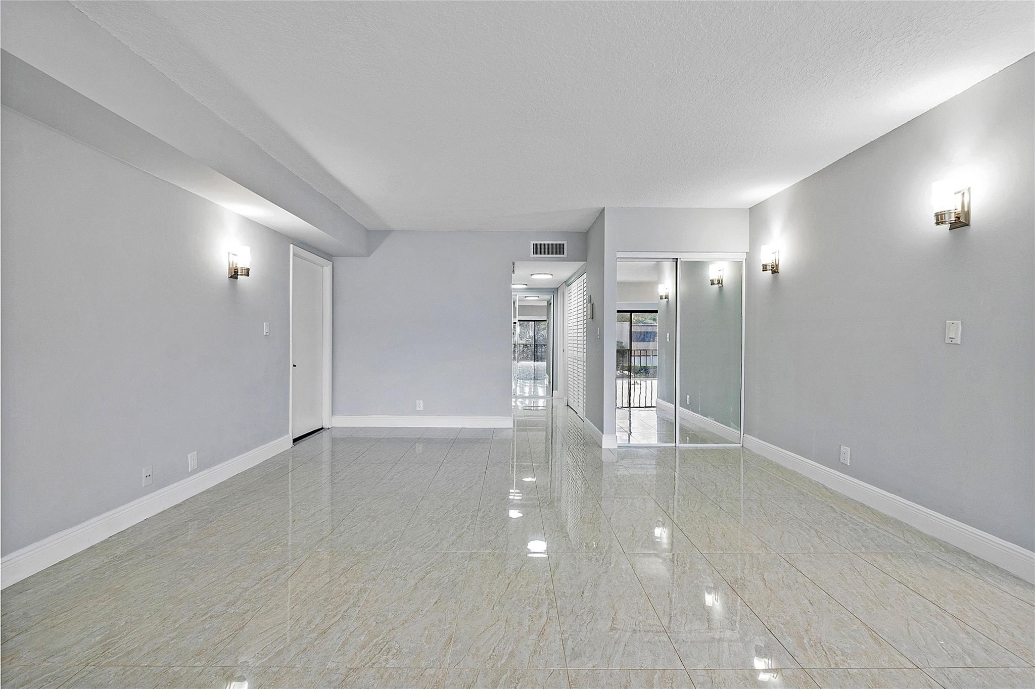 6593 Spring Bottom Way, Unit 237 Boca Raton, FL 33433 - Photo 14 of 49 a view of an empty room with wooden floor and a window