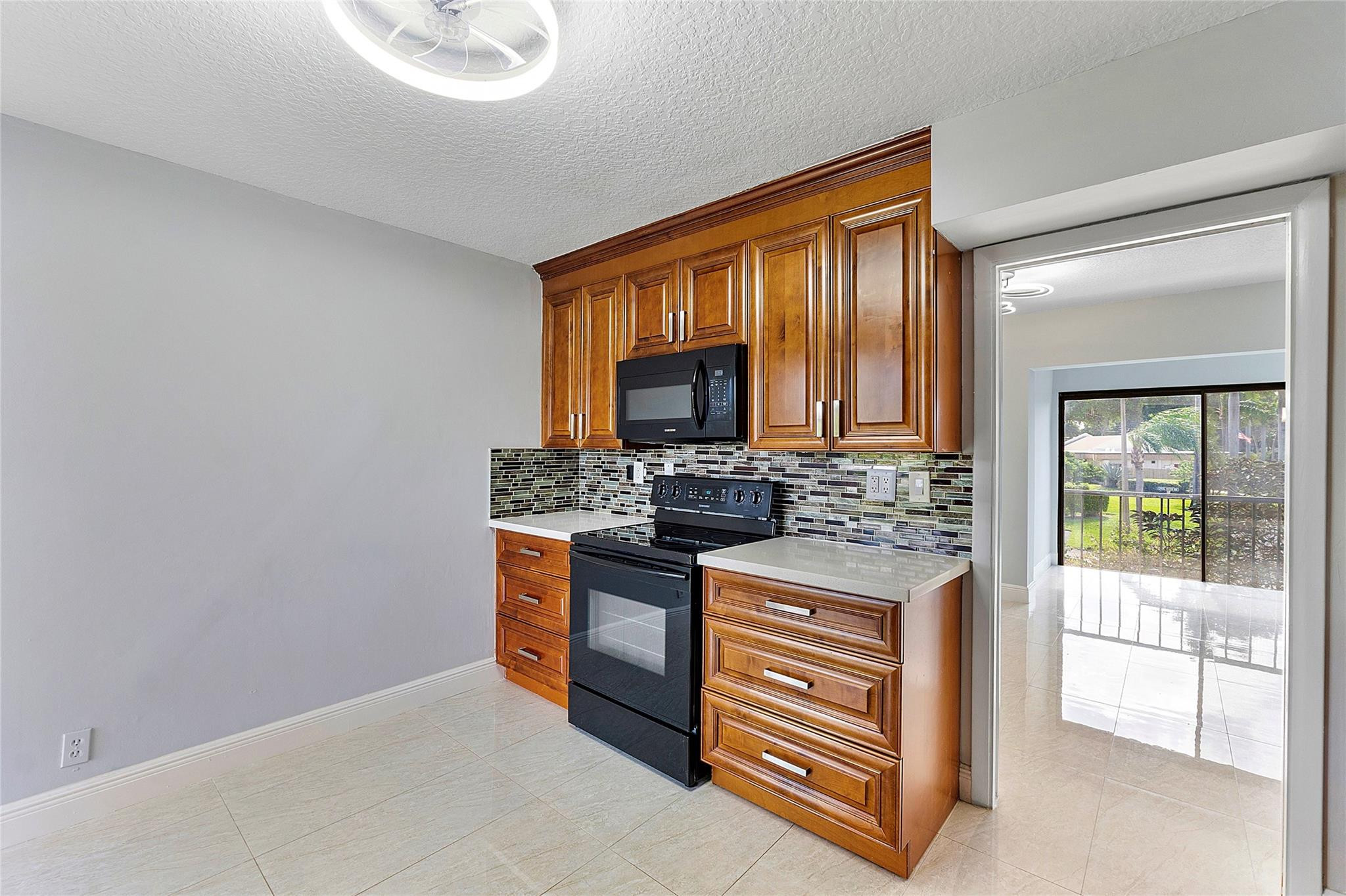 6593 Spring Bottom Way, Unit 237 Boca Raton, FL 33433 - Photo 17 of 49 a kitchen with stainless steel appliances granite countertop a stove and a sink