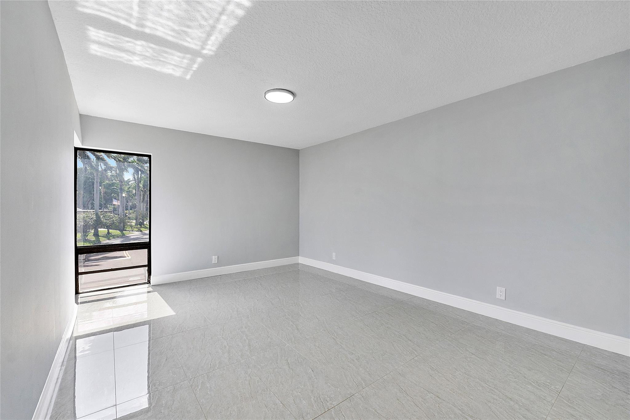 6593 Spring Bottom Way, Unit 237 Boca Raton, FL 33433 - Photo 20 of 49 an empty room with windows