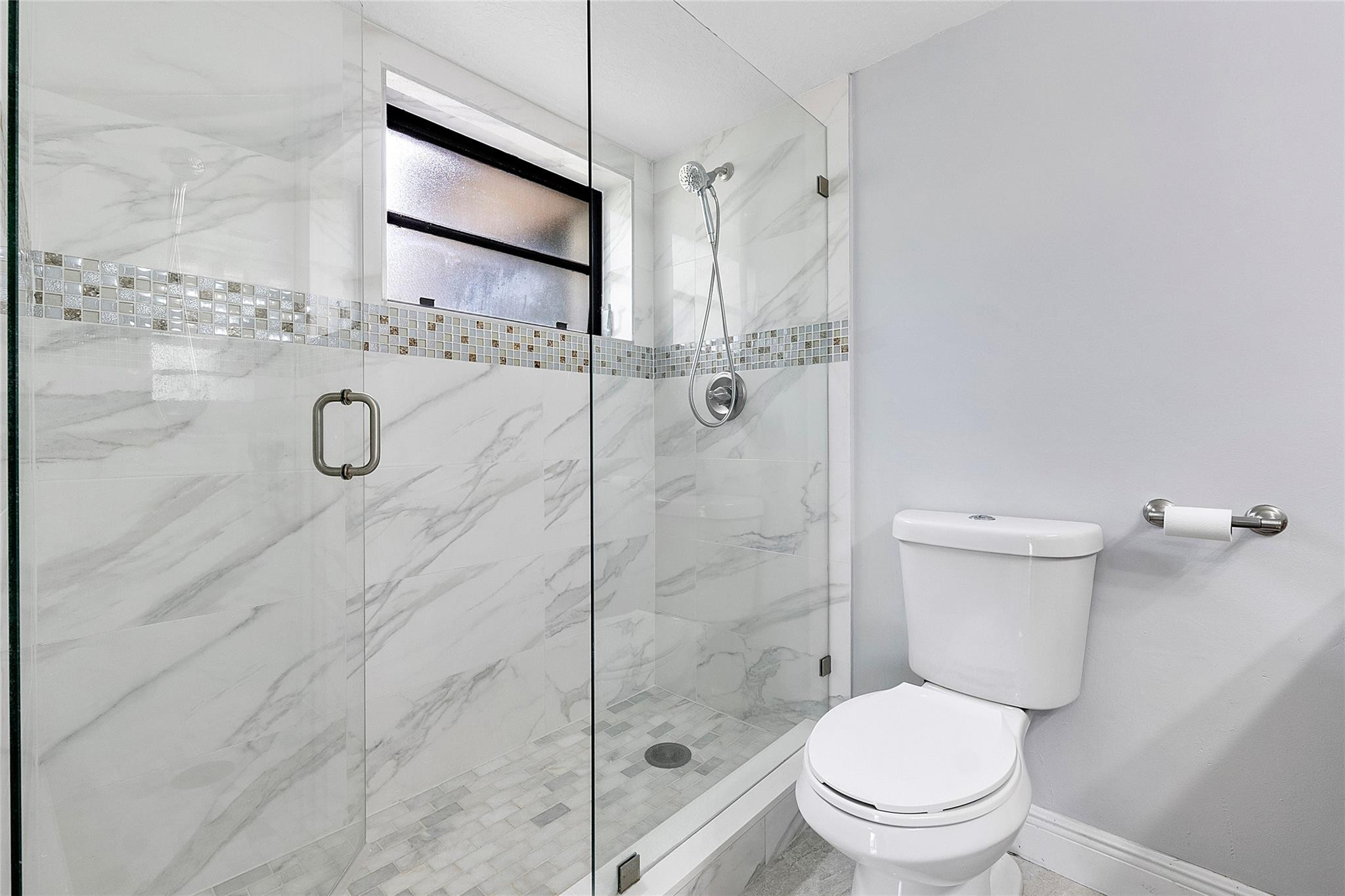 6593 Spring Bottom Way, Unit 237 Boca Raton, FL 33433 - Photo 24 of 49 a bathroom with a granite countertop toilet a sink and shower