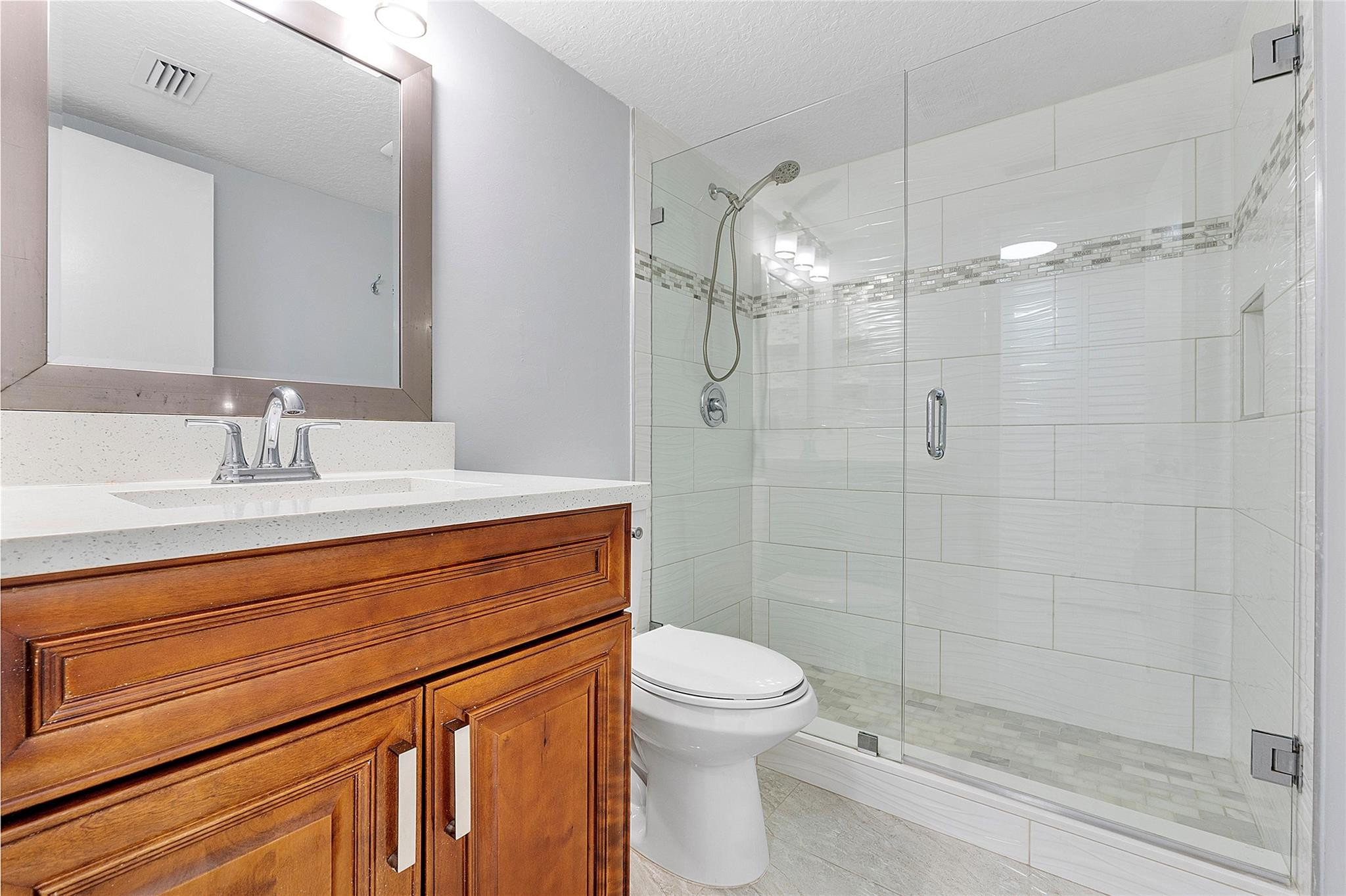 6593 Spring Bottom Way, Unit 237 Boca Raton, FL 33433 - Photo 25 of 49 a bathroom with a sink a toilet and shower