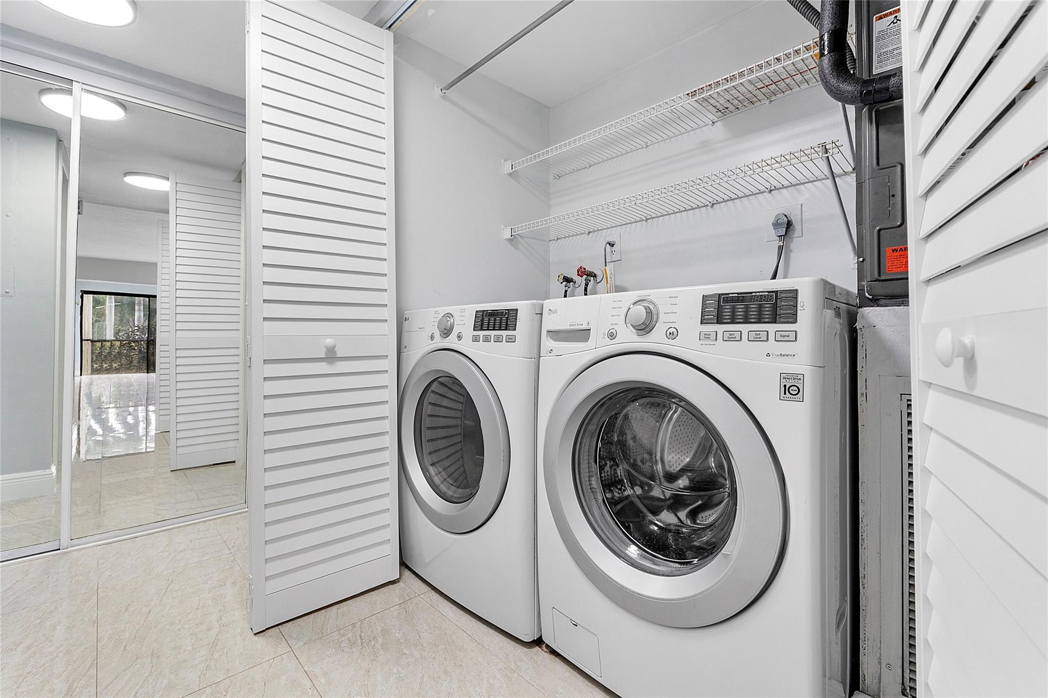 6593 Spring Bottom Way, Unit 237 Boca Raton, FL 33433 - Photo 27 of 49 a view of a hallway with washer and dryer