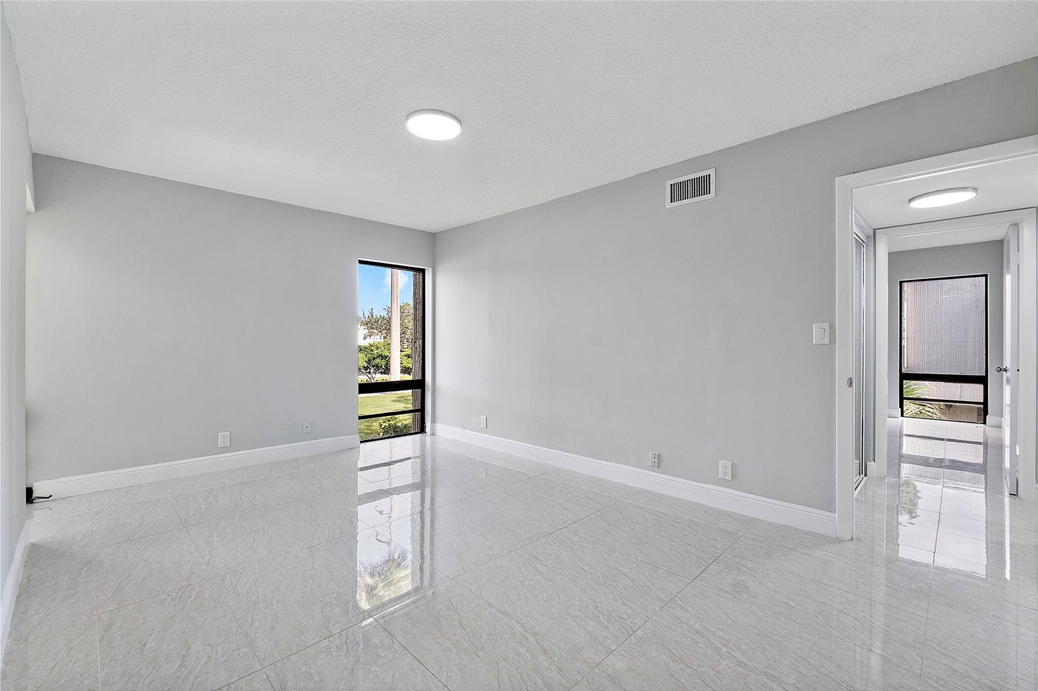 6593 Spring Bottom Way, Unit 237 Boca Raton, FL 33433 - Photo 29 of 49 an empty room with windows and closet