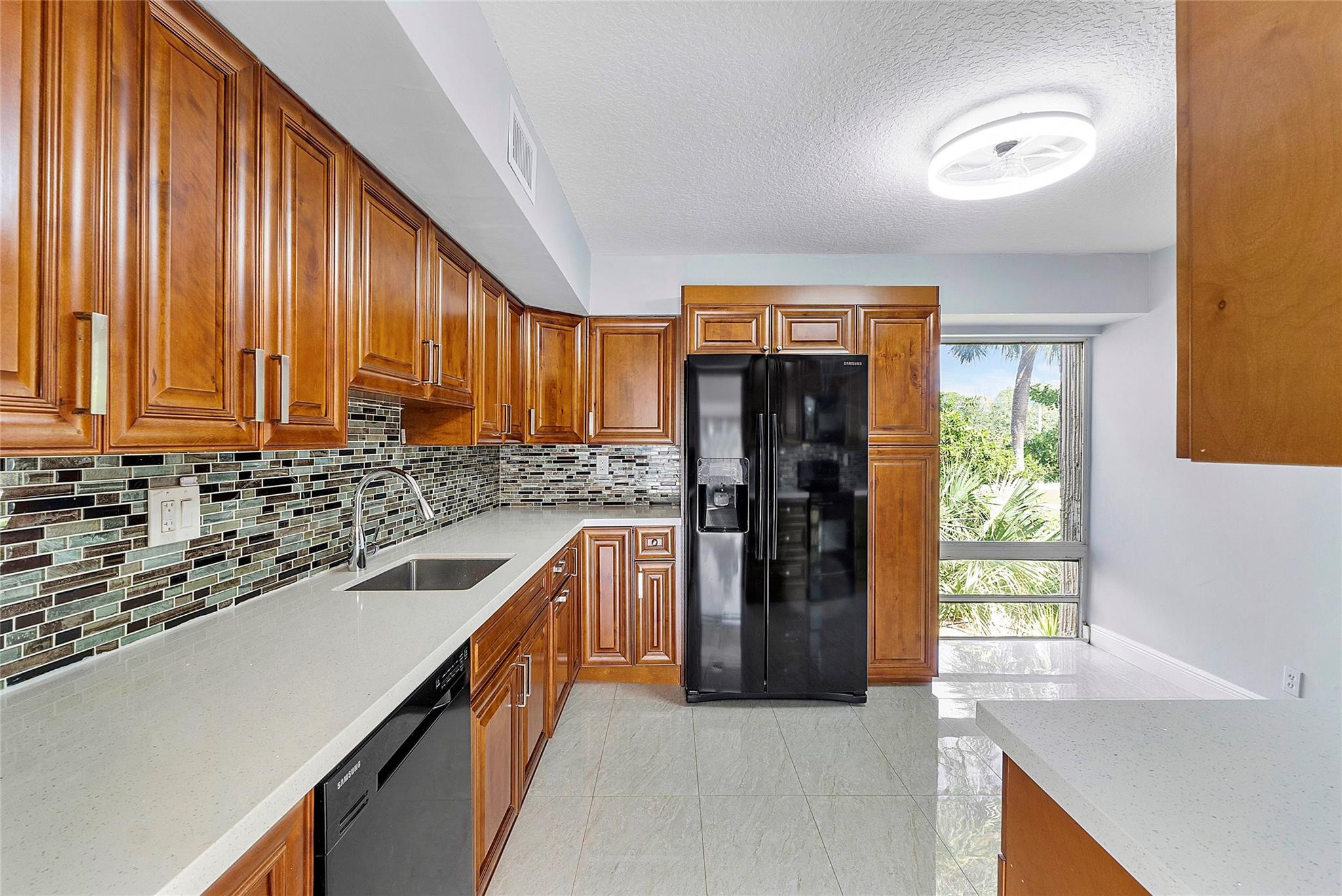 6593 Spring Bottom Way, Unit 237 Boca Raton, FL 33433 - Photo 3 of 49 a kitchen with stainless steel appliances granite countertop a refrigerator a sink and a stove