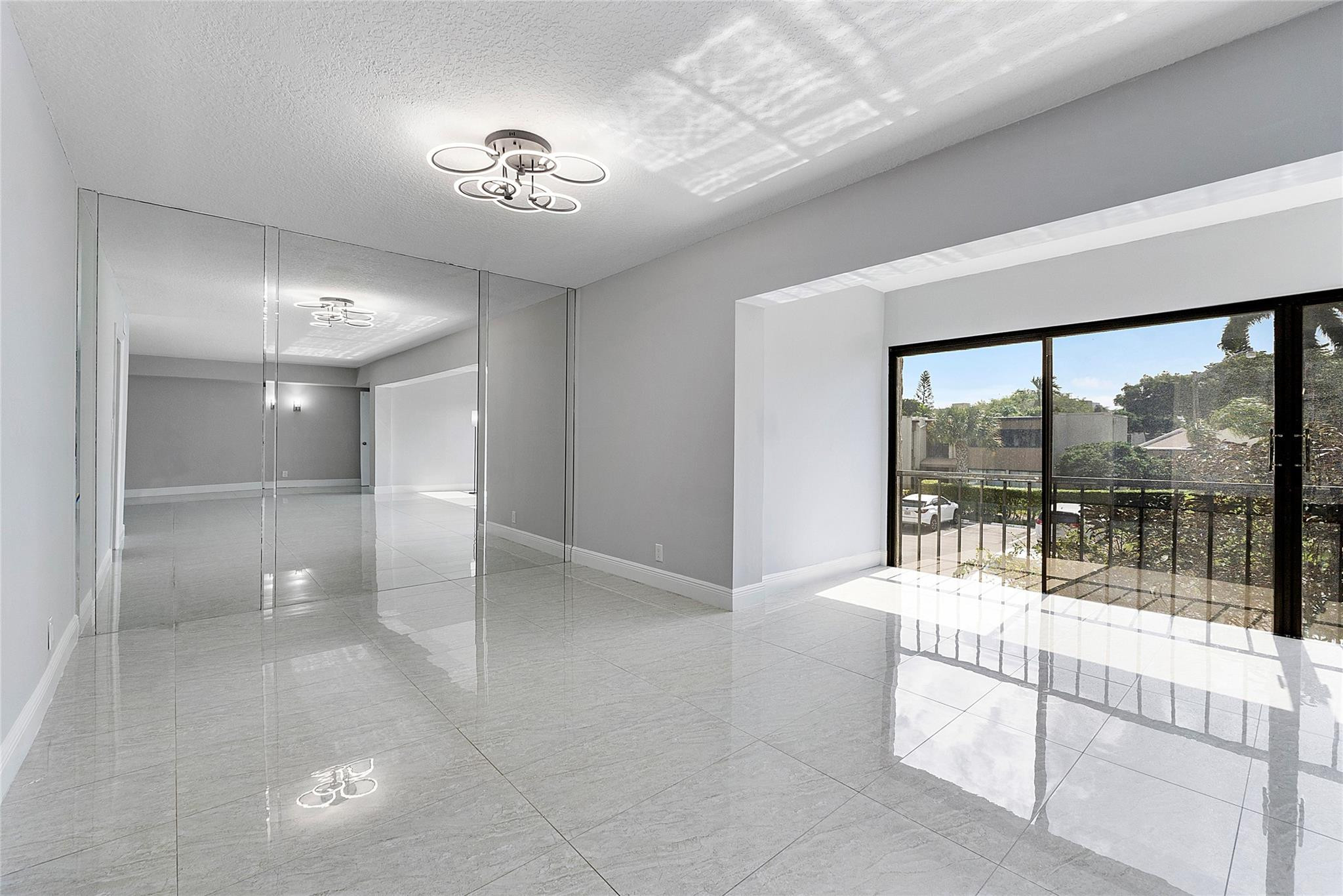 6593 Spring Bottom Way, Unit 237 Boca Raton, FL 33433 - Photo 4 of 49 a large en suite bathroom with a glass shower door and a large window