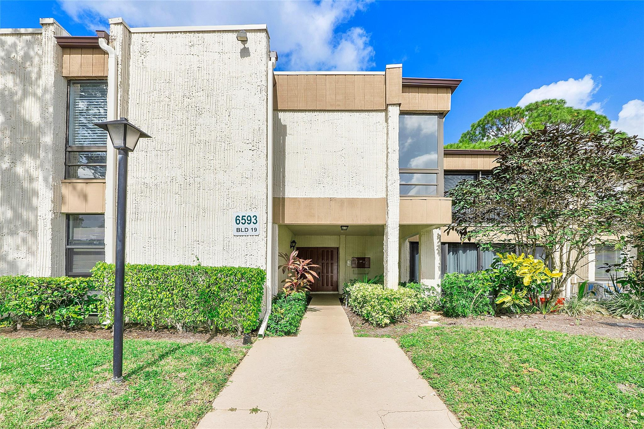 6593 Spring Bottom Way, Unit 237 Boca Raton, FL 33433 - Photo 41 of 49 a view of a house with a yard and plants