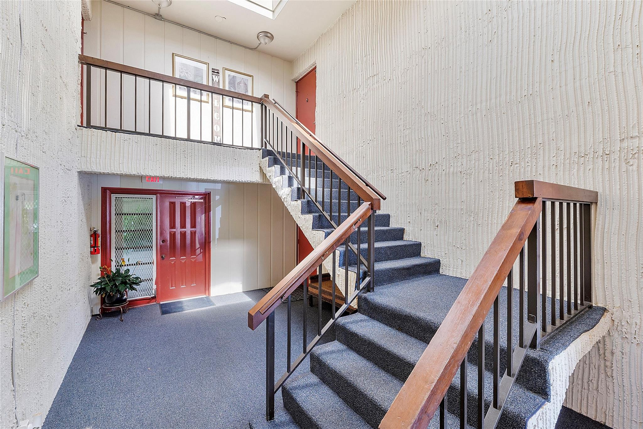 6593 Spring Bottom Way, Unit 237 Boca Raton, FL 33433 - Photo 48 of 49 a view of staircase with lots of frames on wall and windows