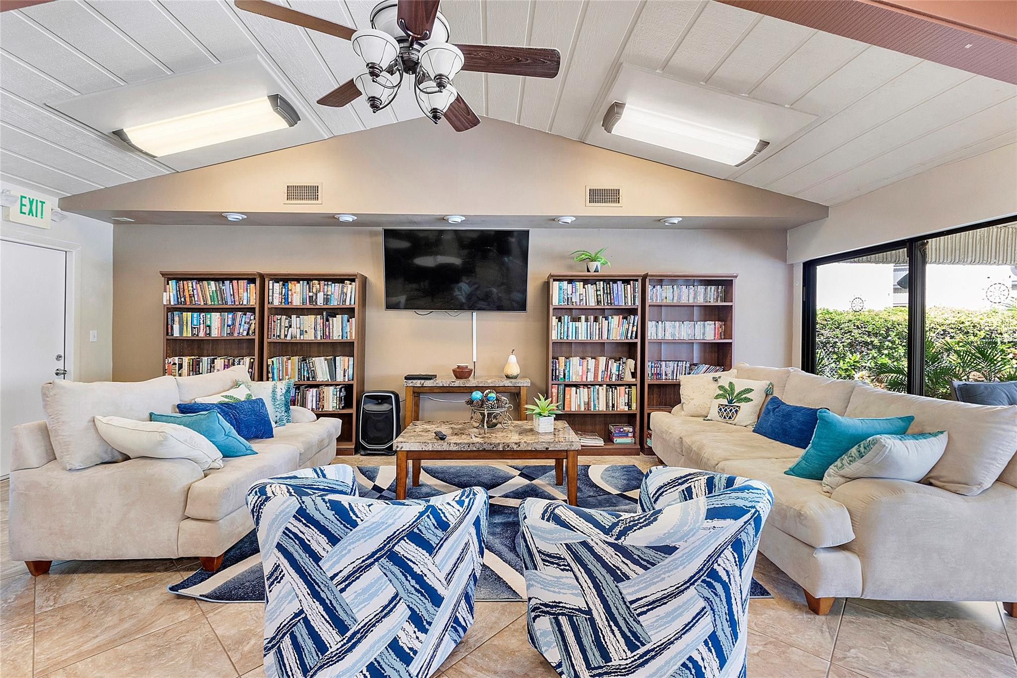 6593 Spring Bottom Way, Unit 237 Boca Raton, FL 33433 - Photo 49 of 49 a living room with furniture a flat screen tv and a large window