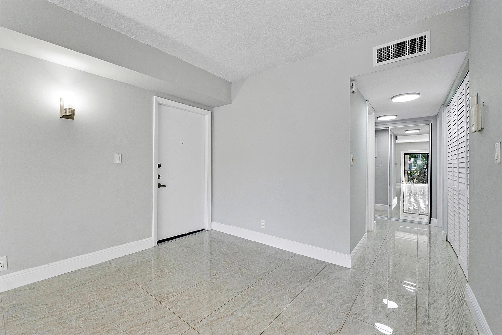 6593 Spring Bottom Way, Unit 237 Boca Raton, FL 33433 - Photo 6 of 49 a view of livingroom with an empty space and a window