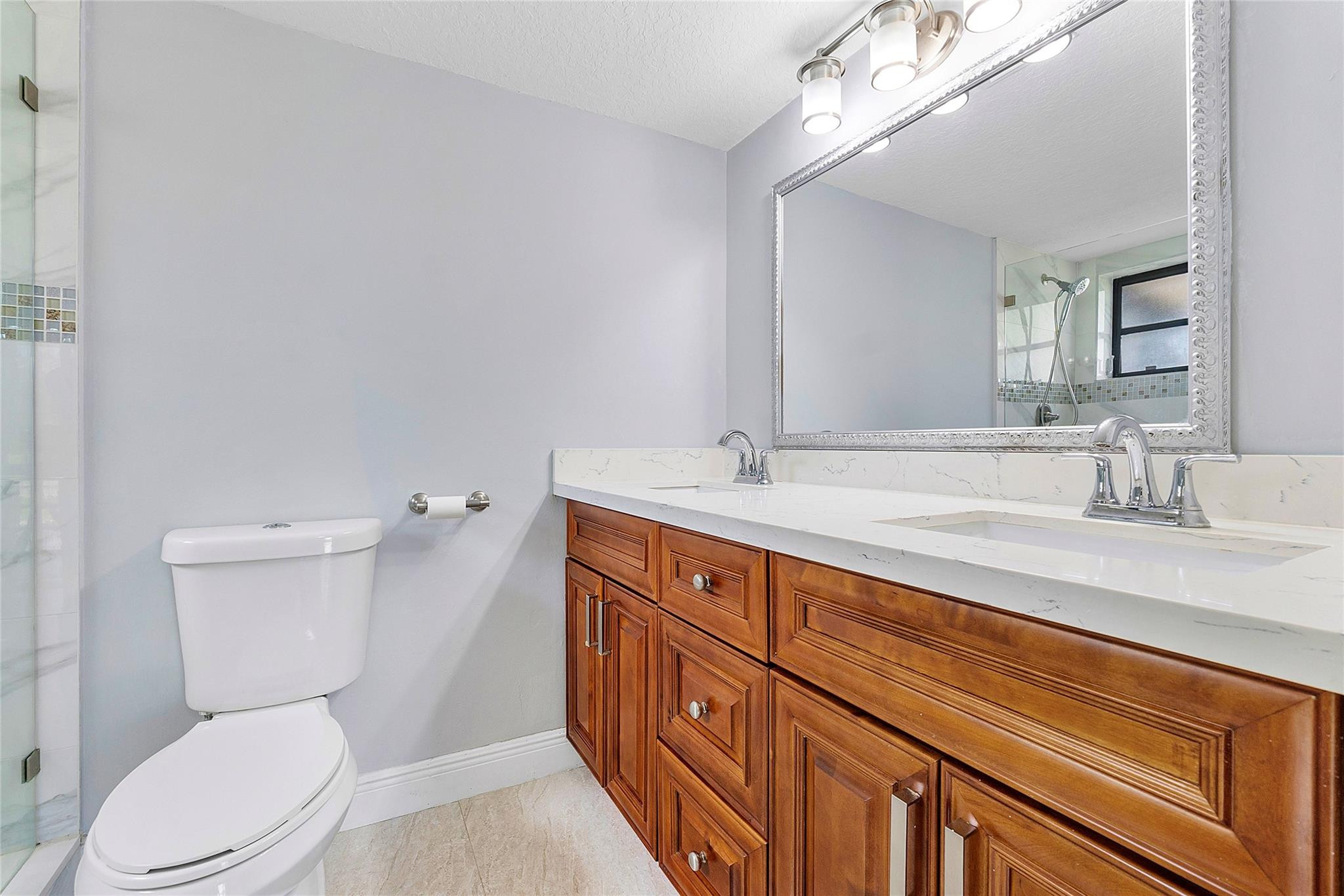 6593 Spring Bottom Way, Unit 237 Boca Raton, FL 33433 - Photo 7 of 49 a bathroom with a toilet a sink and mirror