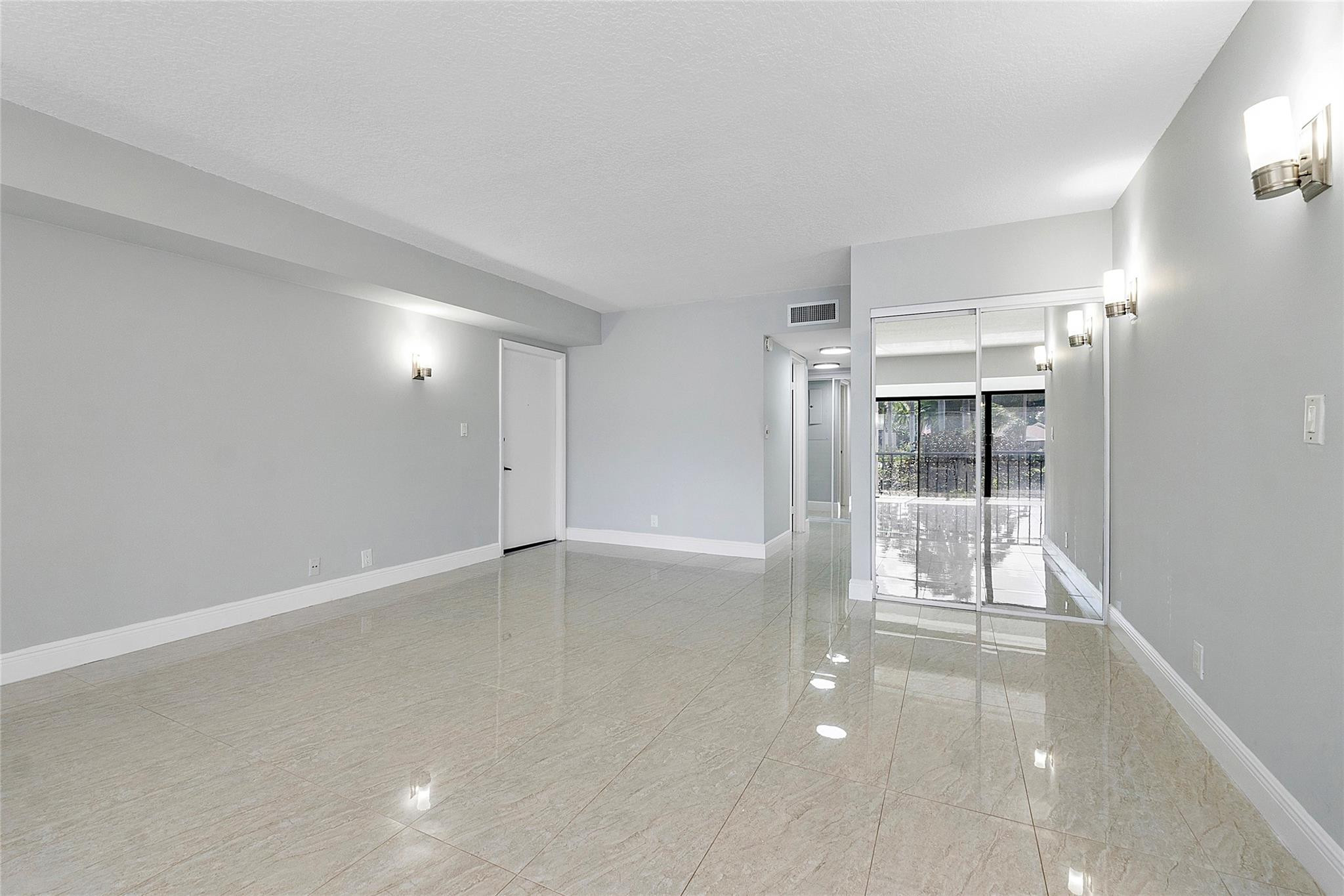 6593 Spring Bottom Way, Unit 237 Boca Raton, FL 33433 - Photo 8 of 49 wooden floor in an empty room with a glass door