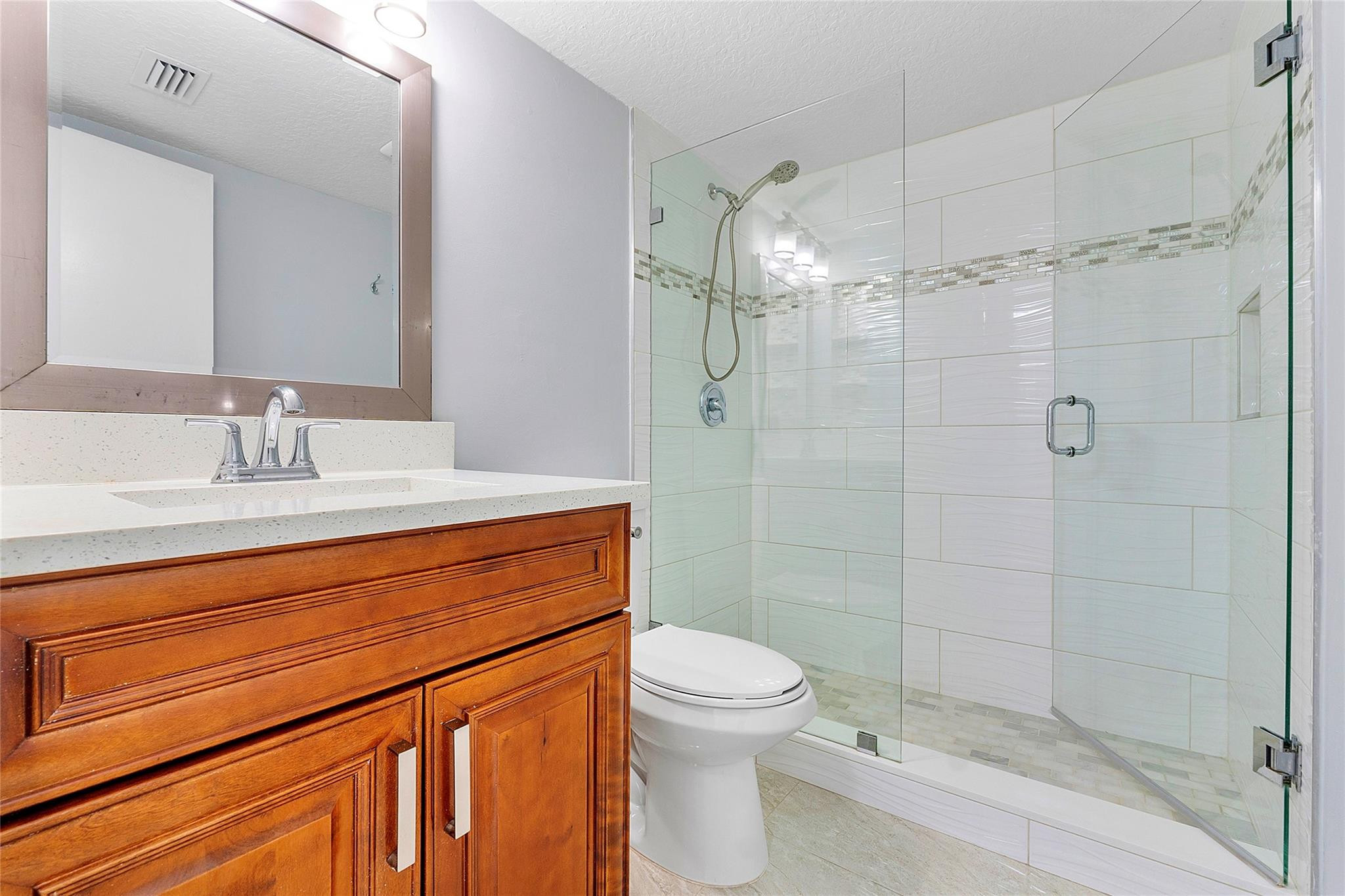6593 Spring Bottom Way, Unit 237 Boca Raton, FL 33433 - Photo 9 of 49 a bathroom with a sink a toilet and shower