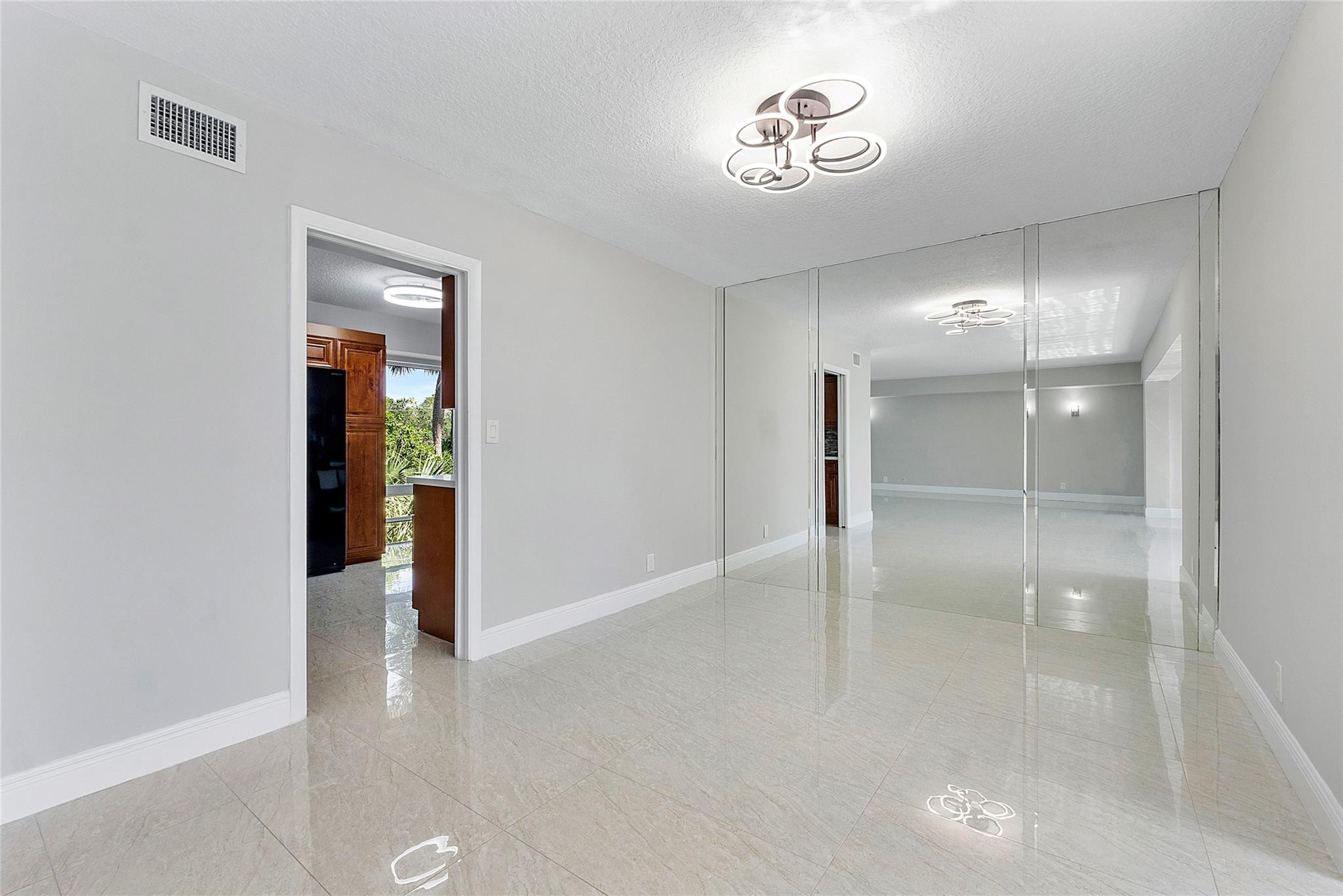 6593 Spring Bottom Way, Unit 237 Boca Raton, FL 33433 - Photo 10 of 49 wooden floor in an empty room with a mirror