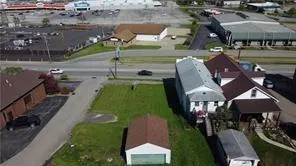 an aerial view of a house with garden space and street view