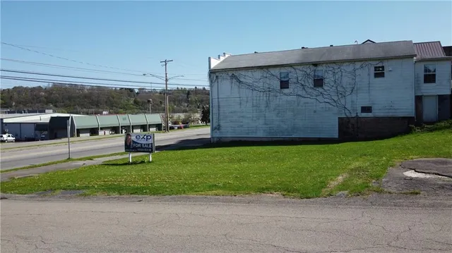 a view of a house with a backyard and a patio