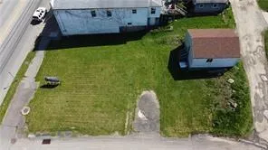 an aerial view of a house with garden space and a patio