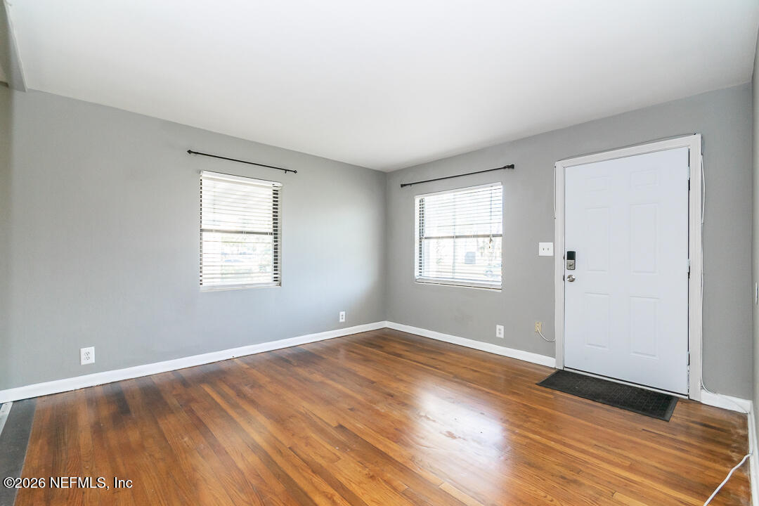 5620 Bagnal Road Jacksonville, FL 32205 - Photo 13 of 31 an empty room with wooden floor and windows