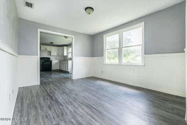 wooden floor in an empty room with a window