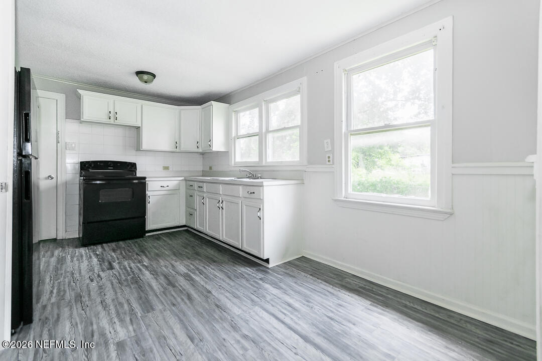 5620 Bagnal Road Jacksonville, FL 32205 - Photo 19 of 31 a kitchen with wooden floors and white appliances