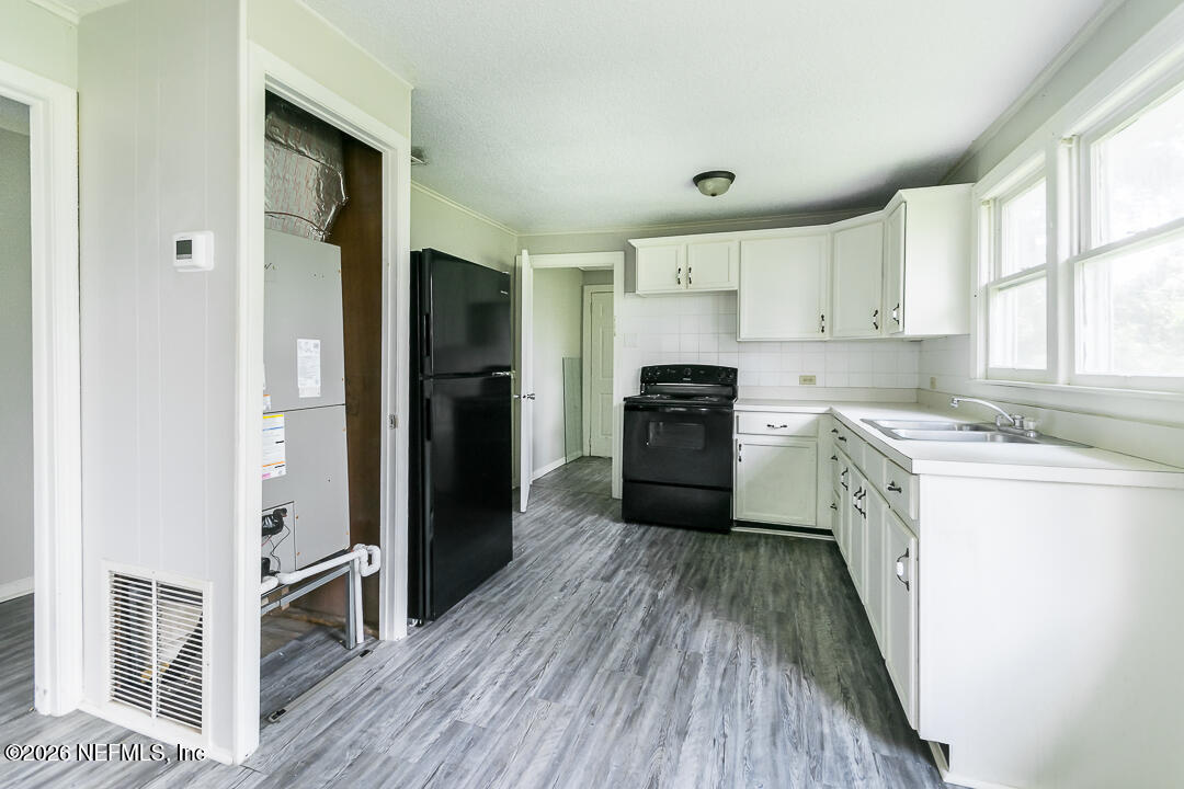 5620 Bagnal Road Jacksonville, FL 32205 - Photo 21 of 31 a kitchen with a refrigerator a sink and dishwasher with wooden floor