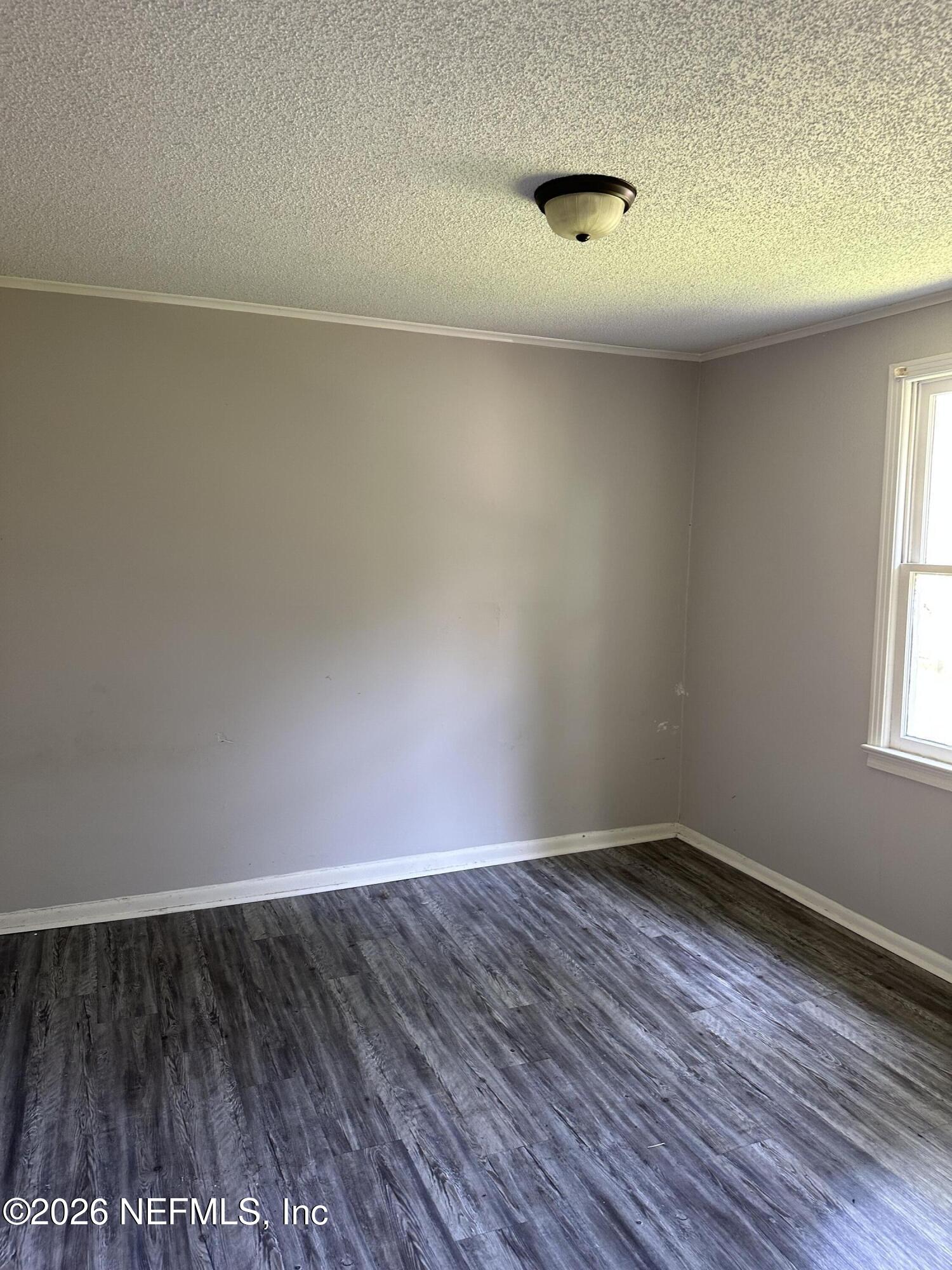 5620 Bagnal Road Jacksonville, FL 32205 - Photo 23 of 31 a view of a room with wooden floor and a window