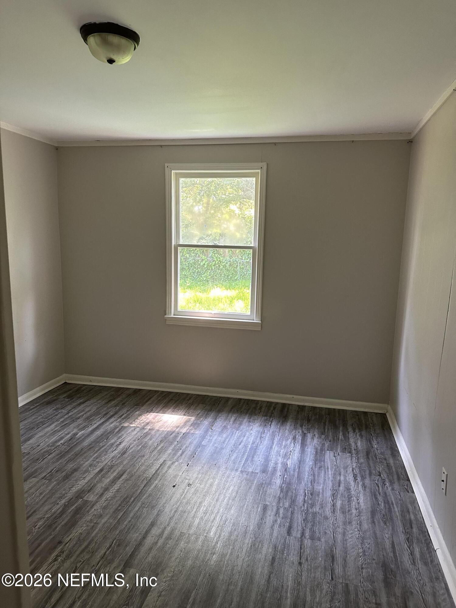 5620 Bagnal Road Jacksonville, FL 32205 - Photo 24 of 31 an empty room with wooden floor and windows