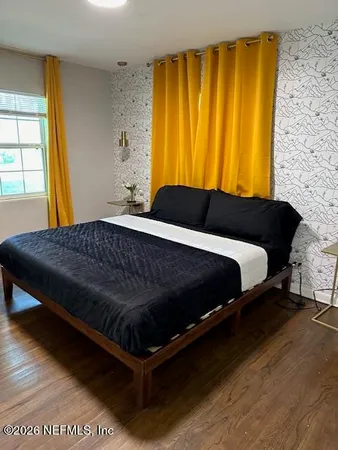 a bedroom with a bed and window