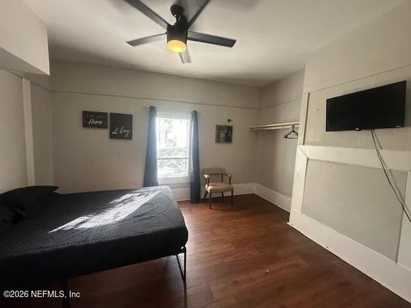 a bedroom with a bed and a television