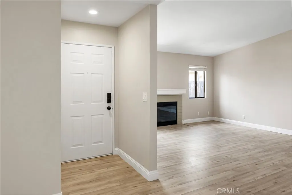 4151 Rexford Drive Hemet, CA 92545 - Photo 5 of 10 an empty room with windows and fireplace