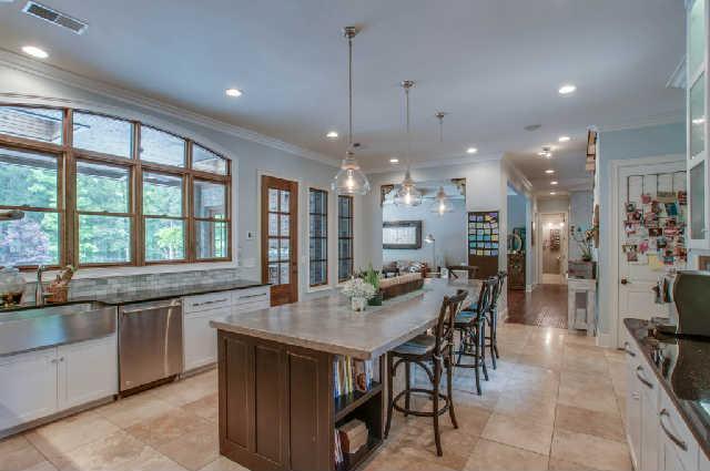 3137 McMillan Road Franklin, TN 37064 - Photo 6 of 20 a kitchen with stainless steel appliances granite countertop table chairs stove and cabinets