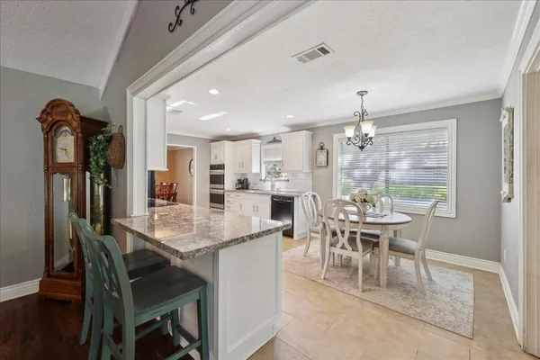 a dining room with furniture and window
