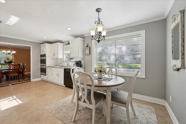 a dining room with furniture and window