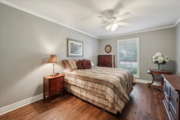 a spacious bedroom with a bed and a chandelier
