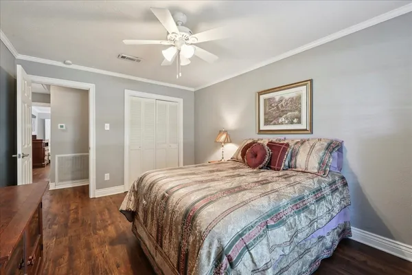 a bedroom with a large bed and a chandelier