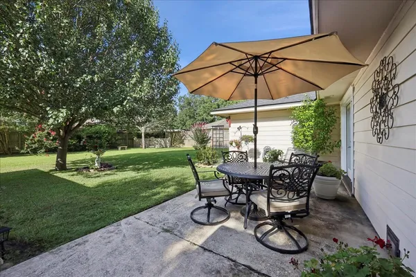 a view of a backyard with furniture and a garden