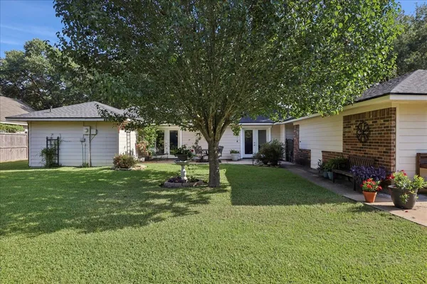 a front view of a house with a garden and porch