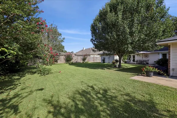 a view of a house with backyard and sitting area
