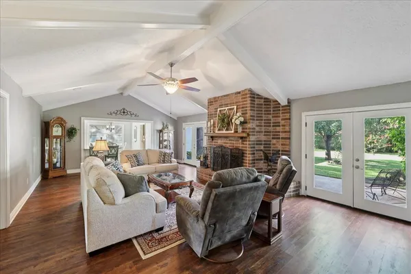 a living room with furniture and a floor to ceiling window