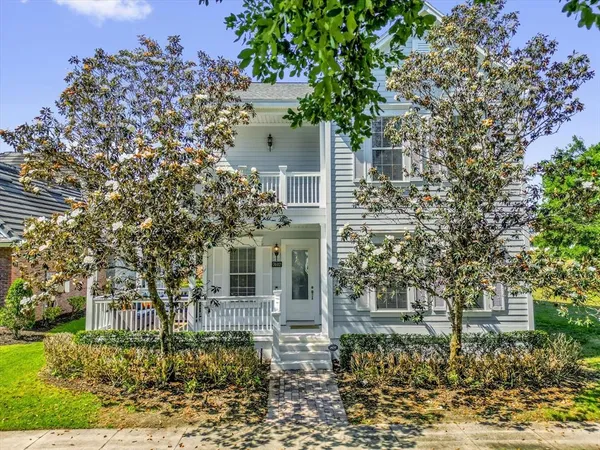 front view of a house with a tree