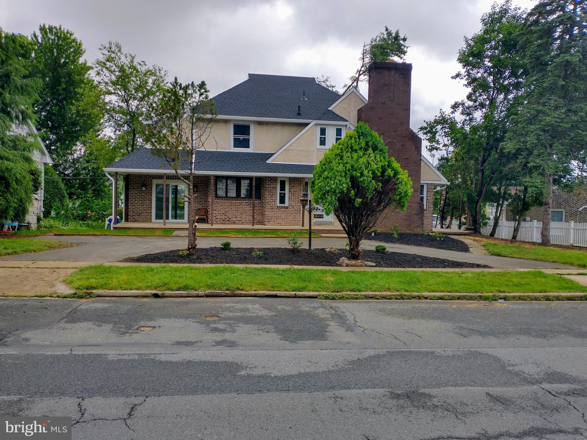 512 Mifflin Boulevard Reading, PA 19607 - Photo 2 of 57 a front view of a house with a yard and potted plants