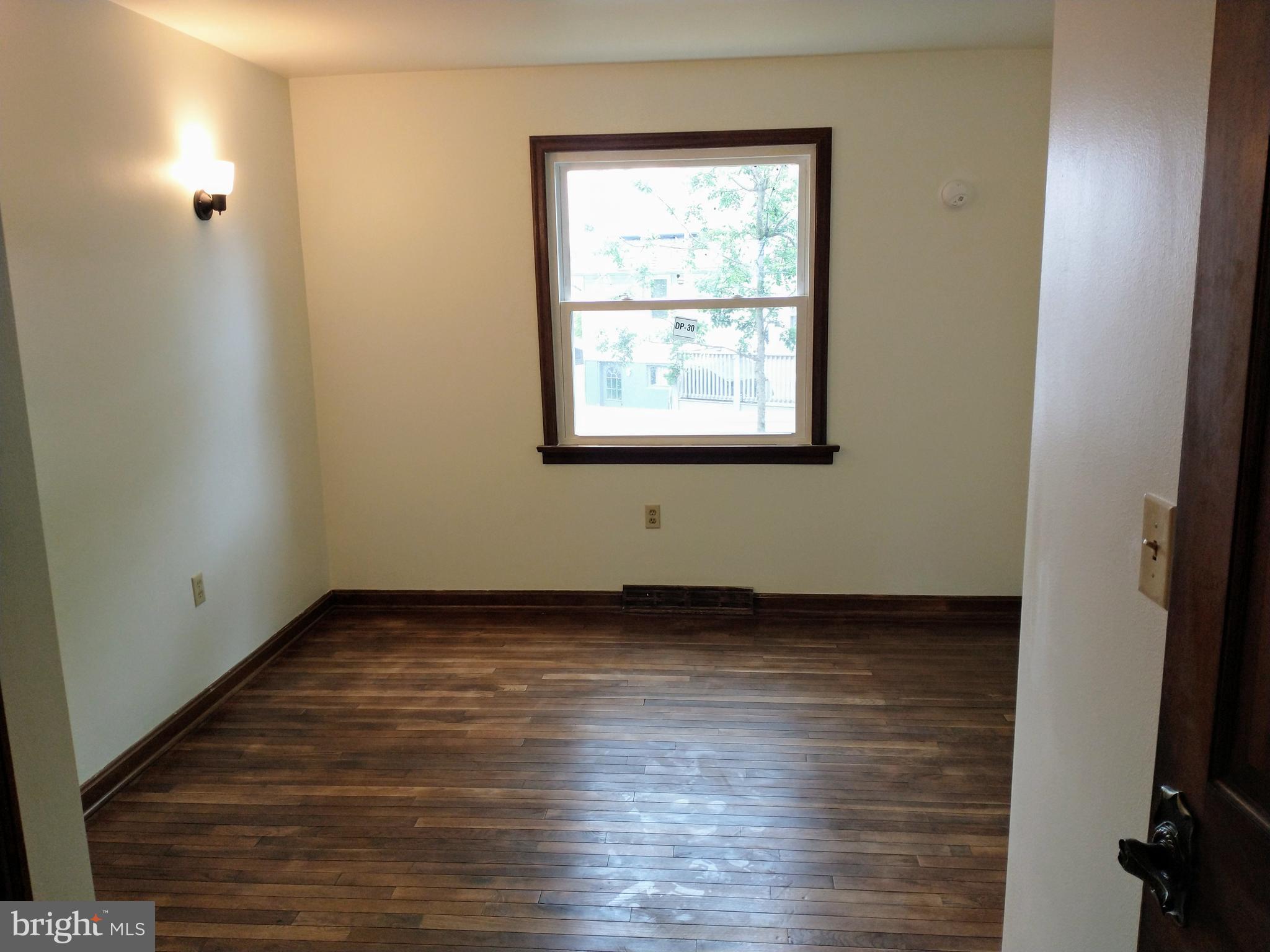 512 Mifflin Boulevard Reading, PA 19607 - Photo 22 of 57 a view of an empty room with wooden floor and a window