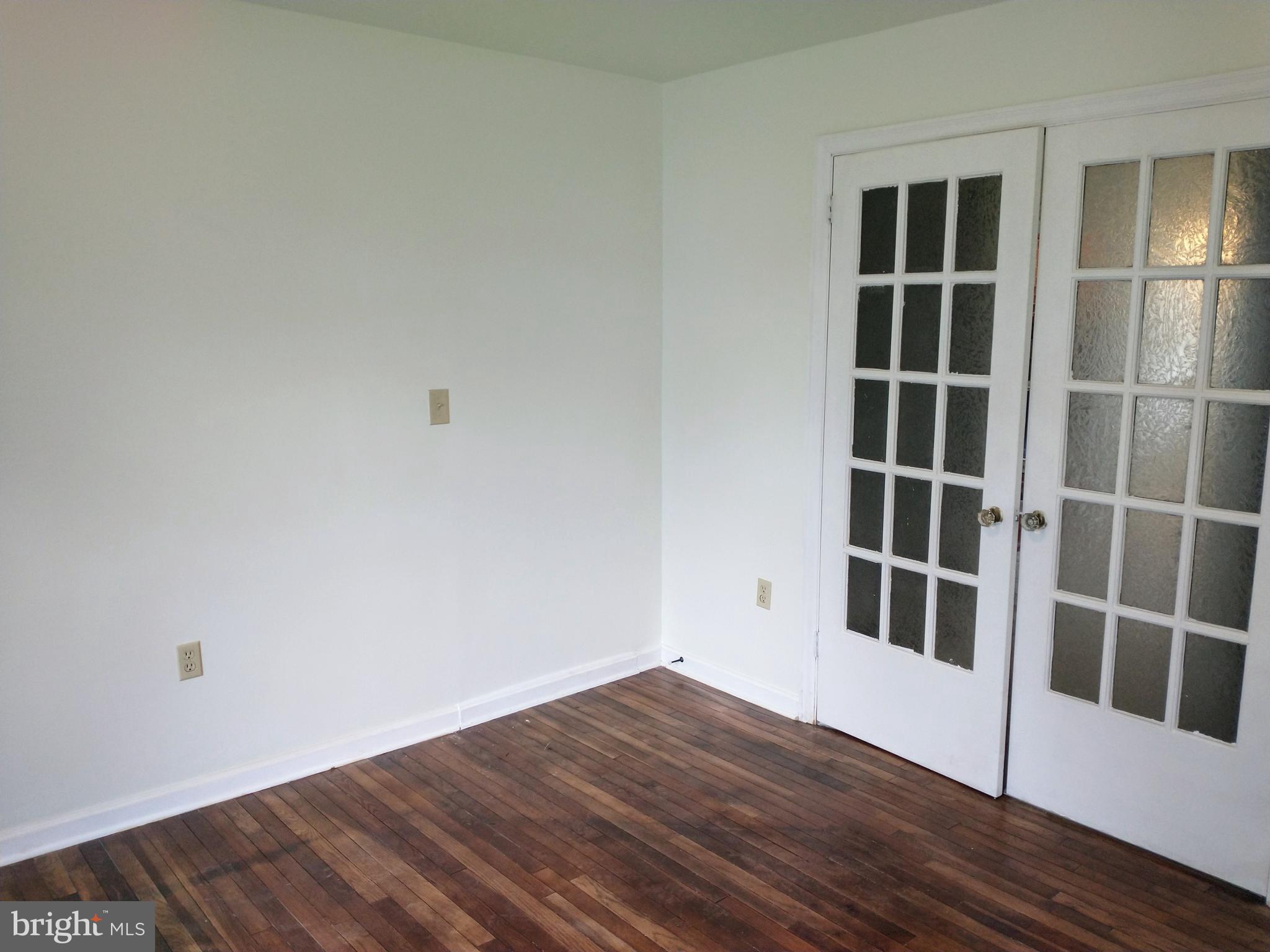 512 Mifflin Boulevard Reading, PA 19607 - Photo 25 of 57 a view of an empty room with wooden floor and windows