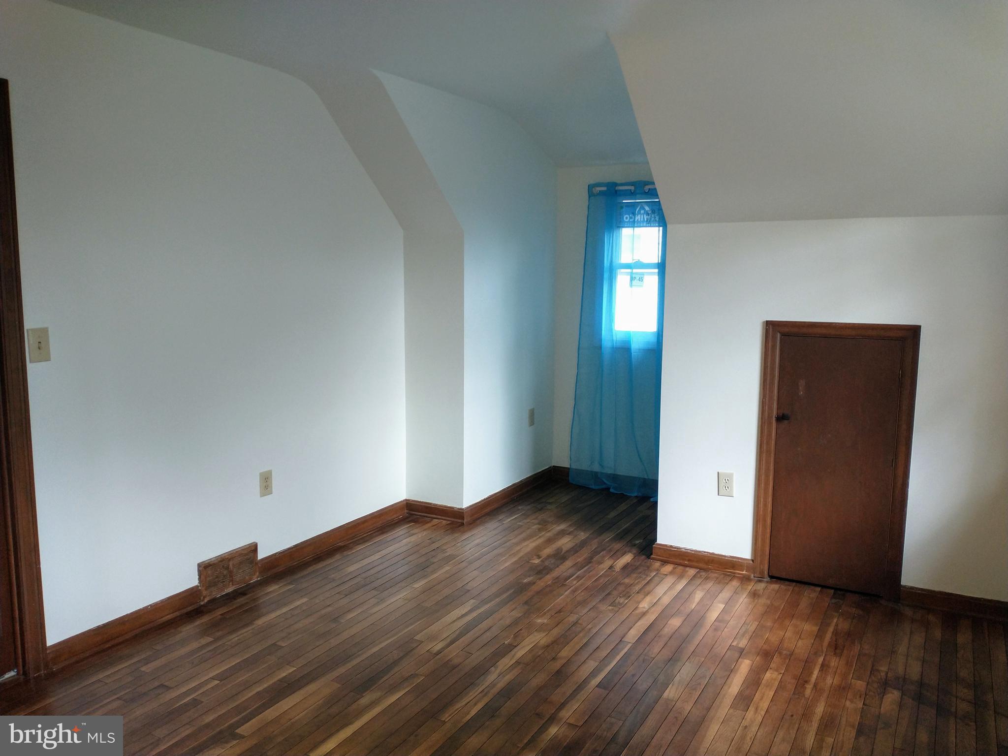 512 Mifflin Boulevard Reading, PA 19607 - Photo 38 of 57 an empty room with wooden floor and windows