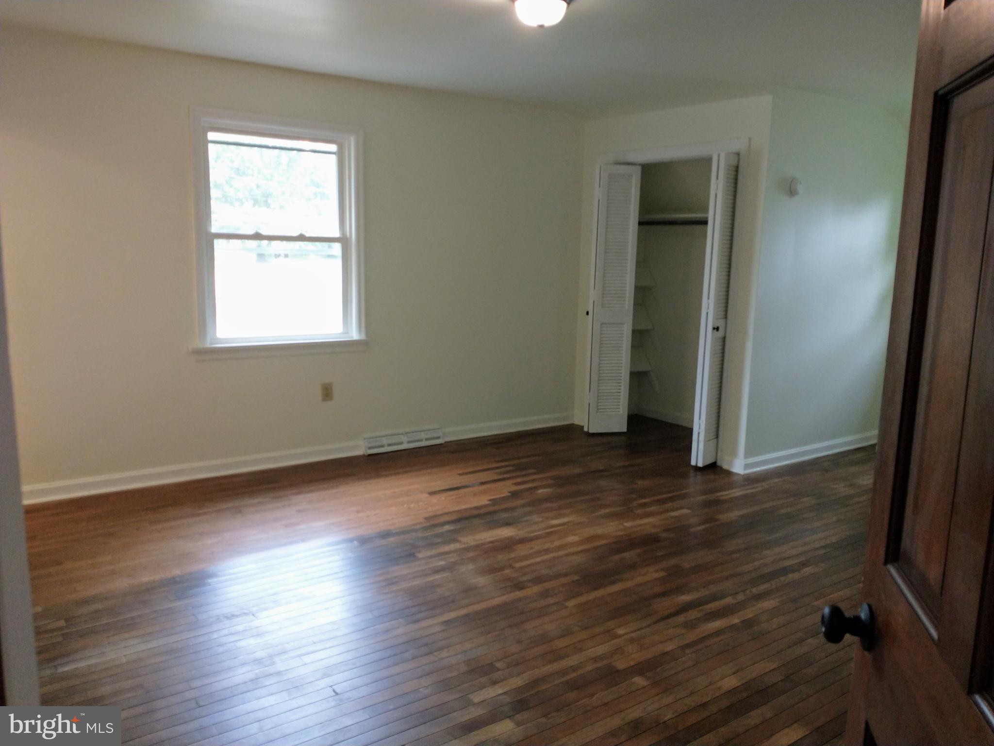 512 Mifflin Boulevard Reading, PA 19607 - Photo 40 of 57 an empty room with wooden floor and windows